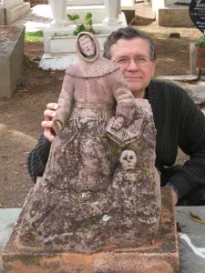 Me posed beside a monument in a Guanajuato  cemetery.