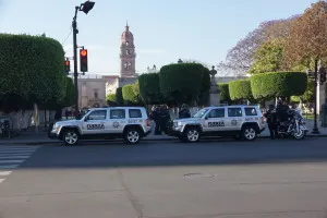 Police cars stationed around a park in Morelia, Michoacan.